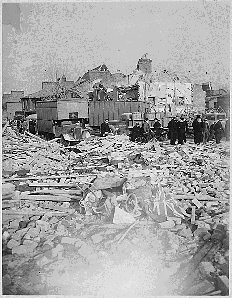 A British Flag lies among the rubble of homes smashed by the Camberwell Road Rocket explosion. V-bomb damage, c1944.  X.png