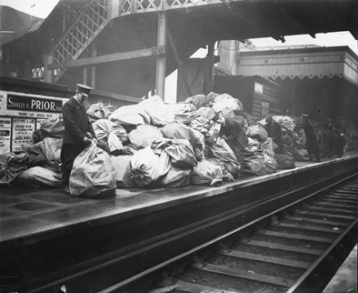 London Bridge Station. Piles of post bags on the platform where the Christmas rush overwhelmed the porters and sorters 1928..png