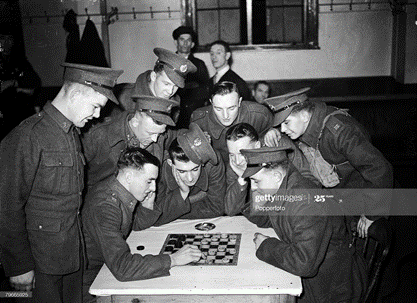 Waterloo Road World War II, London, Young soldiers playing draughts at the Waterloo station canteen provided by the YMCA.   X.png
