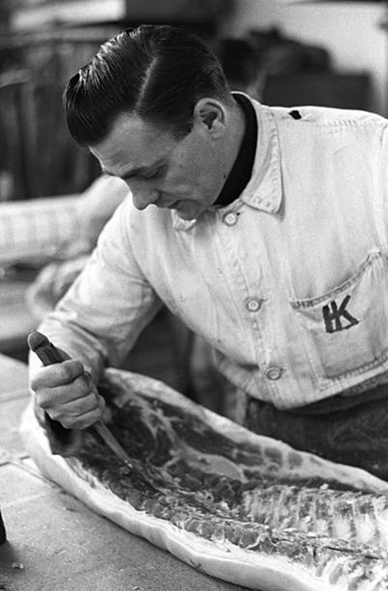 Tooley Street, 10th April 1963, a man cutting meat at a bacon warehouse.   X.jpg